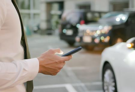 Man on phone near car